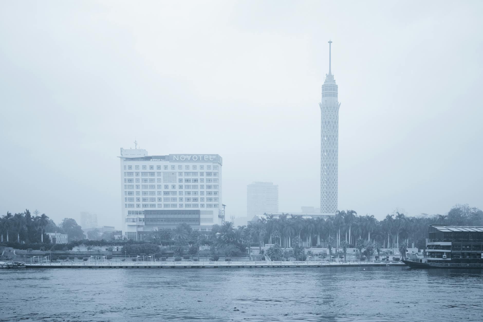 Zamglona panorama Kairu z wieżą Cairo Tower i hotelem nad Nilem